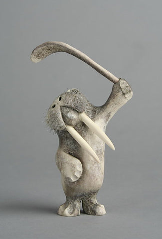 Walrus with Hockey Stick by Tommy Kuniliusee Inuit Artist from Clyde River
